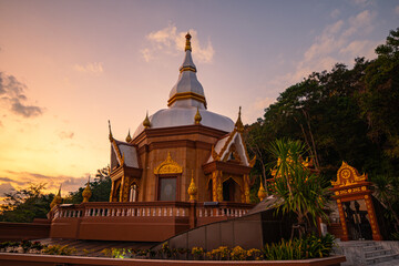 .sunset behind the beautiful pagoda of Langsan temple in Phuket city.Beautiful sky in the evening at the beautiful pagoda on the mountain top..