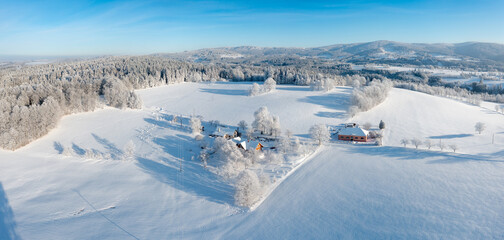 Aerial view to winter landscape. Snow-covered trees at sunny day. Lomy, Osečnice, Orlicke hory, Eagle Mountains