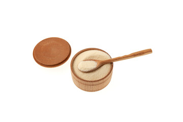Organic Semolina powder. Wheat semolina in wooden bowl with spoon on white background, selective focus, copy space