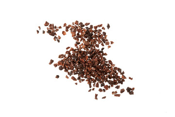 Cocoa nibs scattered on white background. Design element. Crunchy pieces of peeled, crushed and lightly roasted cocoa beans with pleasant chocolate bitterness. Sugar-free product