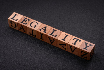 The inscription legality on wooden cubes on a dark concrete background
