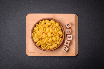 Raw durum wheat gnocchi pasta with salt and spices in a ceramic plate