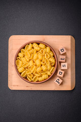 Raw durum wheat gnocchi pasta with salt and spices in a ceramic plate