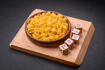 Raw durum wheat gnocchi pasta with salt and spices in a ceramic plate