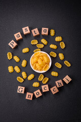 Obraz premium Raw durum wheat gnocchi pasta with salt and spices in a ceramic plate