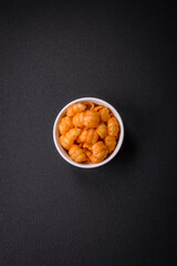 Delicious fresh pasta with pesto sauce, salt, spices and herbs on a ceramic plate