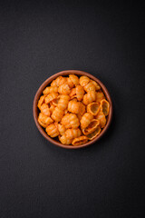 Delicious fresh pasta with pesto sauce, salt, spices and herbs on a ceramic plate