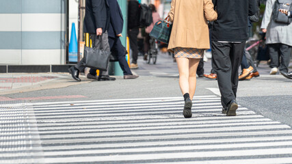 Action of a lovely couple, lady and gentleman, in fashion casual are walk crossing the street...