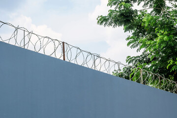 Wall with barbed wire fence