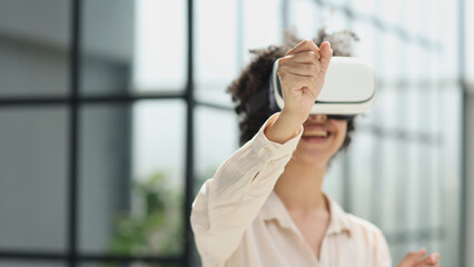 a girl in a modern office uses 3D glasses to study a new project