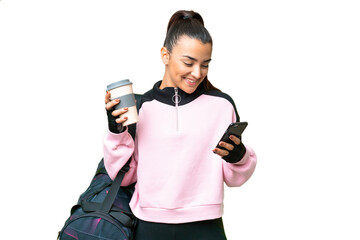 Young sport woman with sport bag over isolated chroma key background holding coffee to take away and a mobile