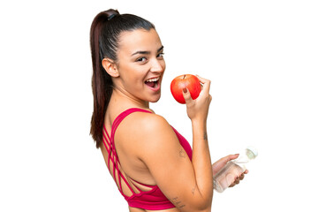 Young beauty woman over isolated chroma key background with an apple and with a bottle of water