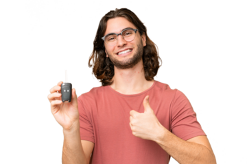 Young handsome man holding car keys over isolated background with thumbs up because something good has happened