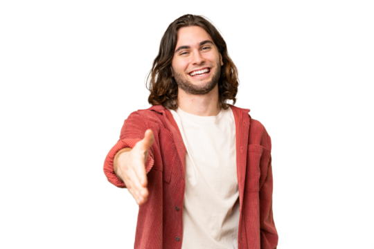 Young handsome man over isolated background shaking hands for closing a good deal