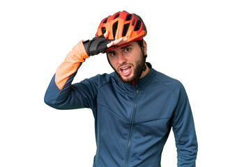 Young cyclist man over isolated chroma key background looking far away with hand to look something - obrazy, fototapety, plakaty