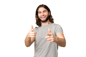 Young handsome man over isolated chroma key background pointing to the front and smiling