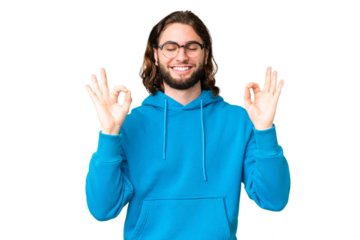 Young handsome man over isolated chroma key background in zen pose