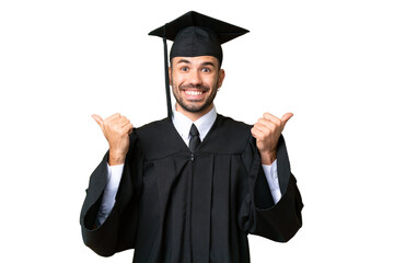 Young university graduate man over isolated chroma key background with thumbs up gesture and smiling