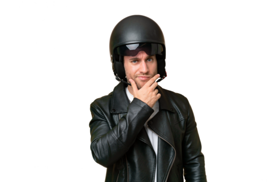 Young caucasian man with a motorcycle helmet isolated on green chroma background thinking