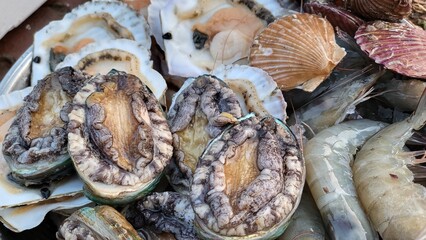 Seafood Delight: Assortment of Fresh and Appetizing Abalone, Scallop, and Shrimp