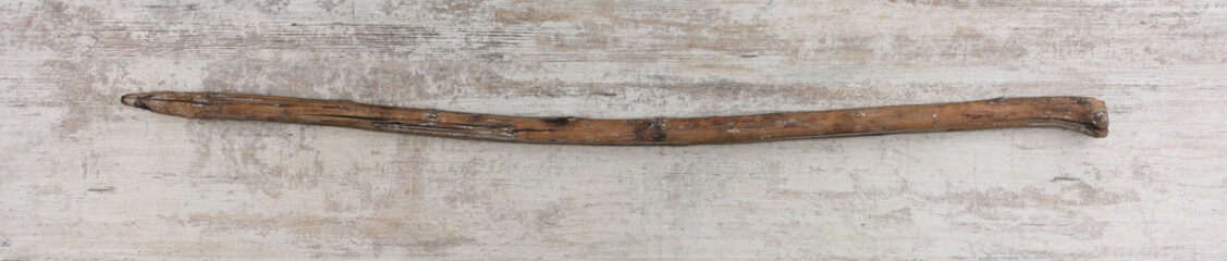 primitive wooden spear on wooden background