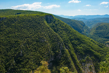 Fototapeta premium The summer landscape in the hills overlooking Martin Brod, Bihac, in the Una National Park. Una-Sana Canton, Federation of Bosnia and Herzegovina. Early September