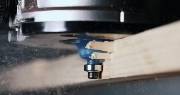 cutting the edge of the board with wood router in joinery. woodworking and carpentry