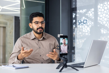 Successful business trainer teacher recording online training video course, man inside office at...
