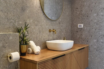modern hotel bathroom sink with gold faucet