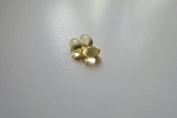 Macro of three softgel capsules of vitamin D