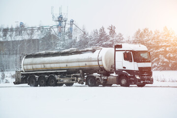 Semi truck on the winter road. A big industrial truck delivering goods in cold weather after the...