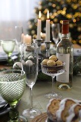 Christmas table setting with festive decor and glassware indoors