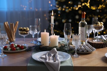 Christmas table setting with festive decor and dishware indoors