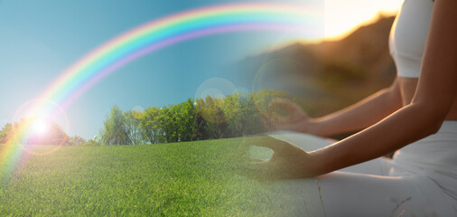 Woman meditating outdoors and bright rainbow over meadow, double exposure. Banner design