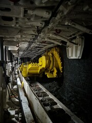 Close up shot of an roller shear loader mining coal