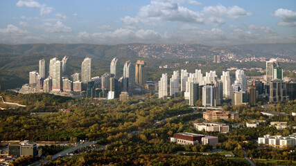 Aerial view  to a modern city with skyscrapers, dormitory area and parks.