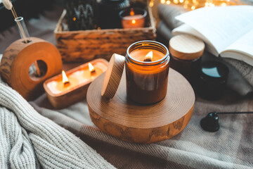 Burning candle in a festive cozy interior
