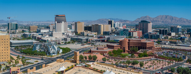 Aerial cityscape view featuring a blend of modern skyscrapers and traditional buildings, with a circular park complex in Las Vegas.
