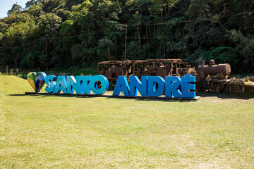 Santo André city sign in Paranapiacaba with an old train in the background