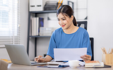 Asian Business woman work in home. concept of tax, report, accounting, statistics, and analytical research.
