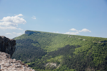 Beautiful landscape of mountains, rocks, green forest and blue sky