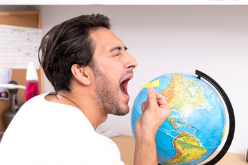 A man holds a paper airplane poised over a globe, embodying the spirit of adventure and travel