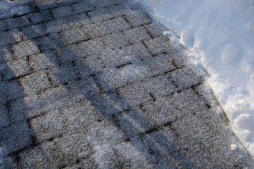 Pavement covered with a thick layer of ice with a high risk of slipping