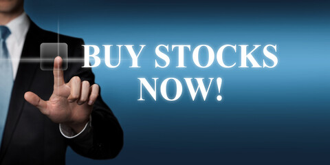 buy stocks now - businessman pressing virtual touchscreen button