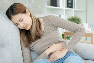 stomach ache. Asian women have abdominal pain, indigestion, gastritis, menstrual cramps,...