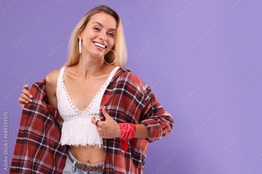 Wall mural Portrait of happy hippie woman on purple background. Space for text