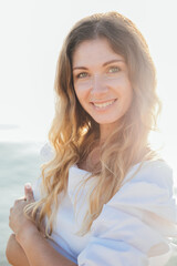 Portrait of a beautiful smiling woman in a summer light dress