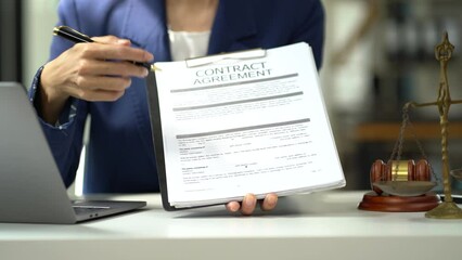 Female Legal counsel working with paperwork on his desk in office workplace working with tablet computer. Justice and law concept.