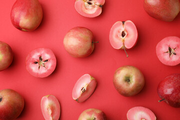Tasty apples with red pulp on color background, flat lay