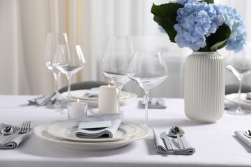 Beautiful table setting with floral decor indoors